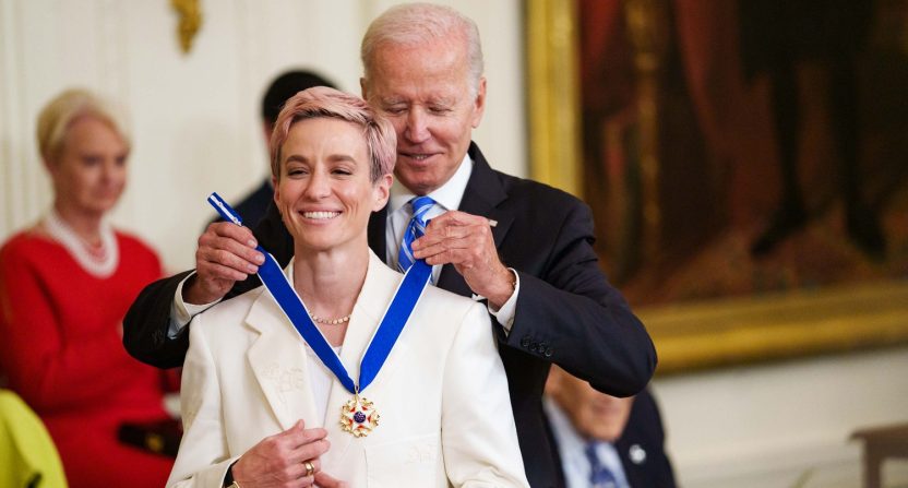 Professional soccer player Megan Rapinoe reacts as she receives the Presidential Medal of Freedom from President Joe Biden at The White House.