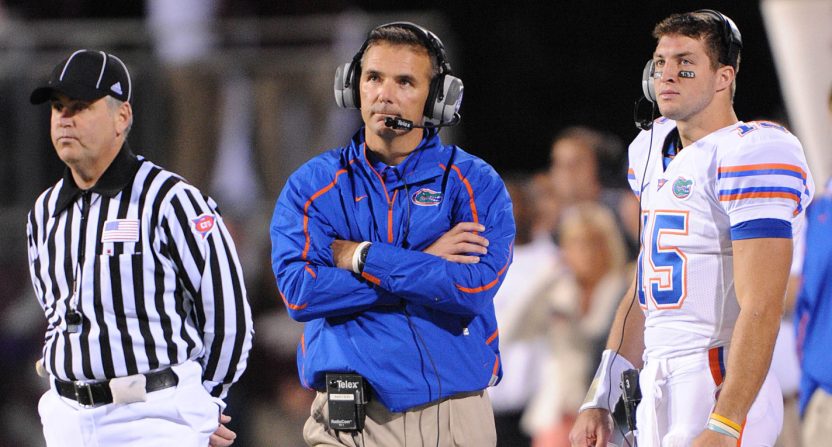Oct 24, 2009; Starkville, MS, USA; Florida Gators head coach Urban Meyer (center) and quarterback Tim Tebow (15) watch the scoreboard during a time out against the Mississippi State Bulldogs in the first half at Davis Wade Stadium. The Gators beat the Bulldogs 29-19. Mandatory Credit: Don McPeak-USA TODAY Sports