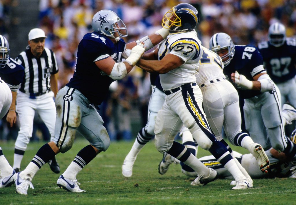 Dallas Cowboys linebacker Randy White (54) and San Diego Chargers tackle Sam Claphan (77) in action at Jack Murphy Stadium. 