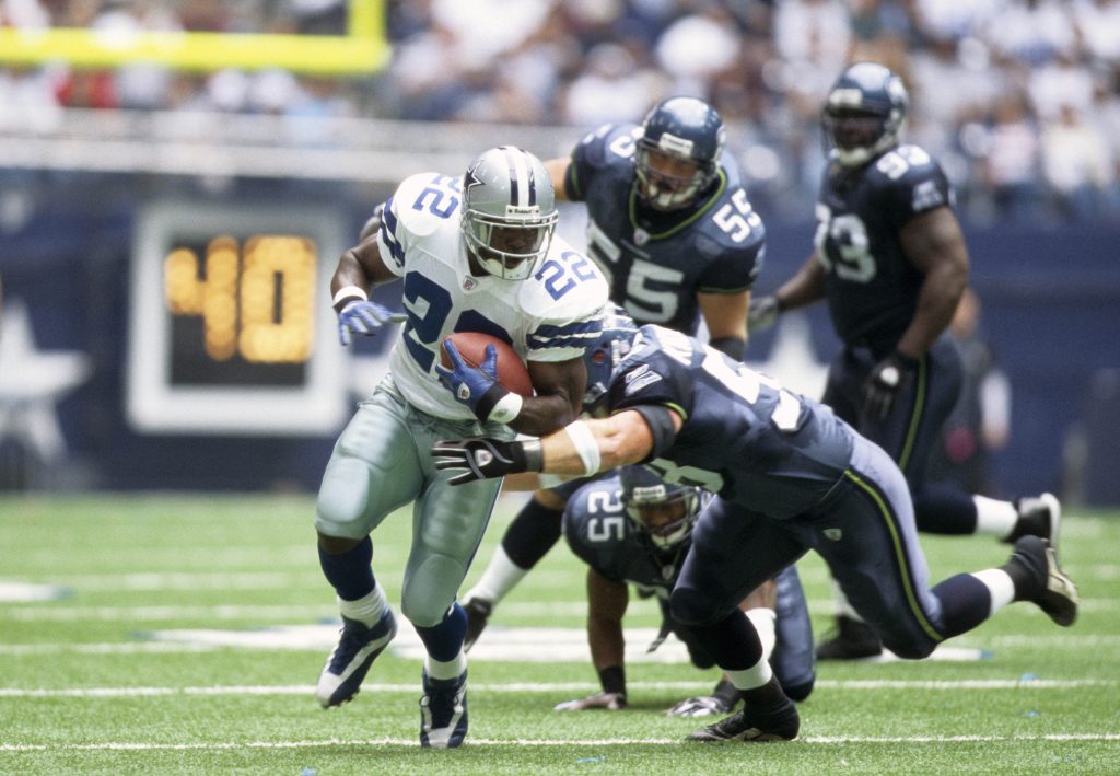 Dallas Cowboys running back Emmitt Smith (22) breaking the NFL's all time rushing record against the Seattle Seahawks at Texas Stadium. 
