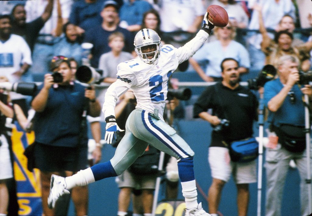 Dallas Cowboys defensive back Deion Sanders (21) celebrating as he scores a touchdown on an interception against the Chicago Bears at Texas Stadium.